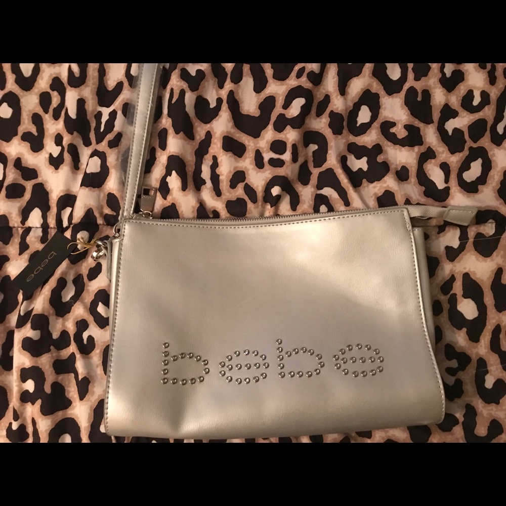 Bebe clutch purse with wrist strap